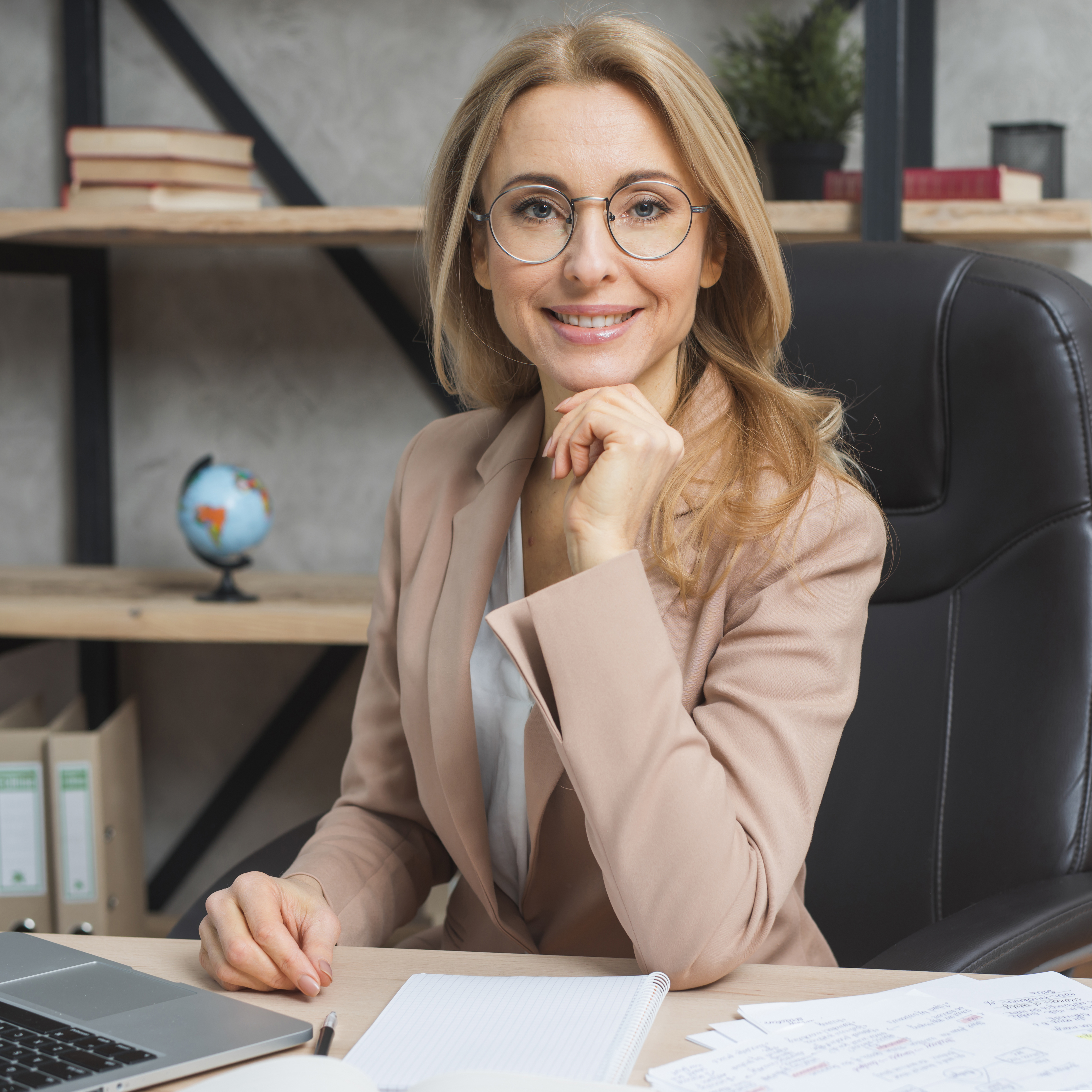 portrait-confident-young-blonde-businesswoman-sitting-chair-workplace